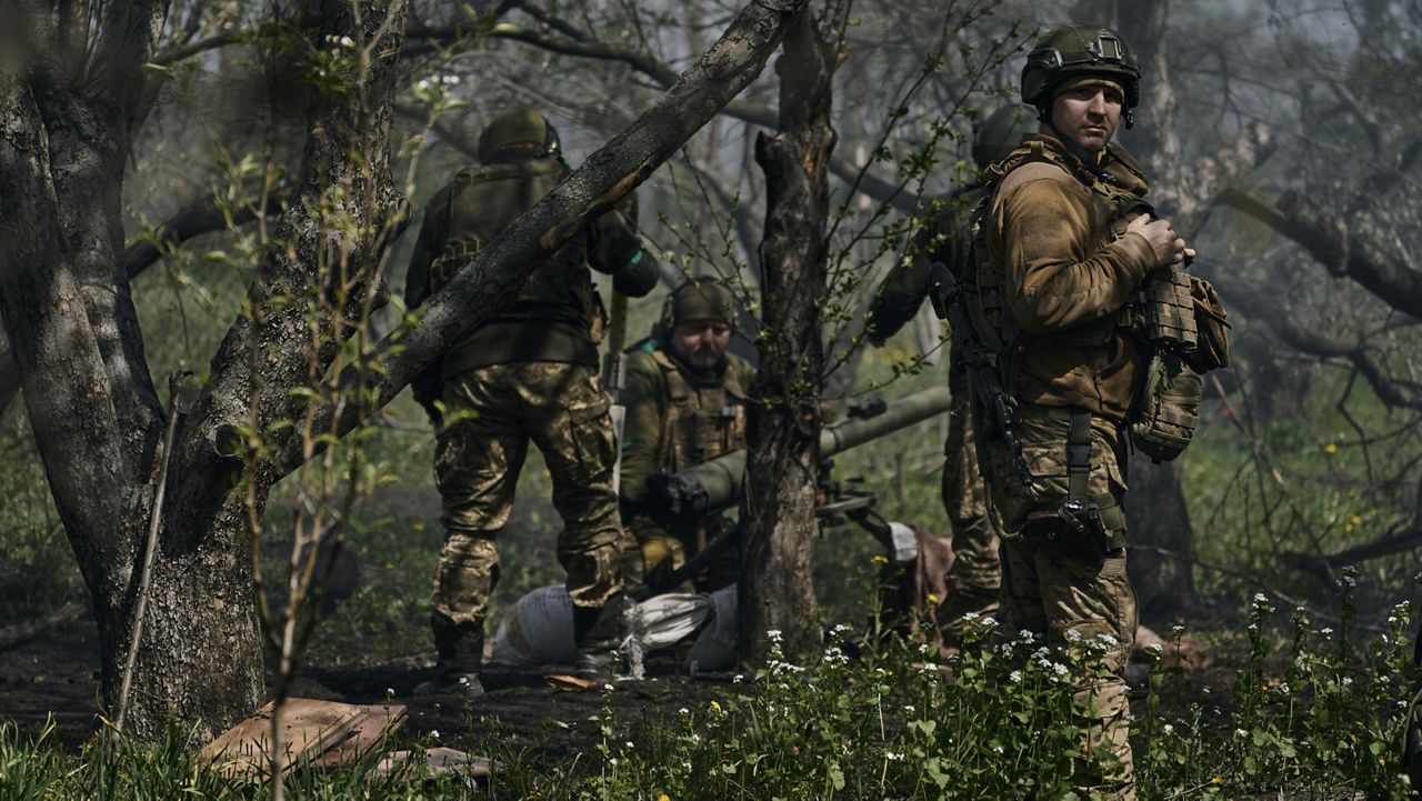 Ukrainian soldiers prepare Wednesday to fire a cannon in Bakhmut. (AP Photo/Libkos)