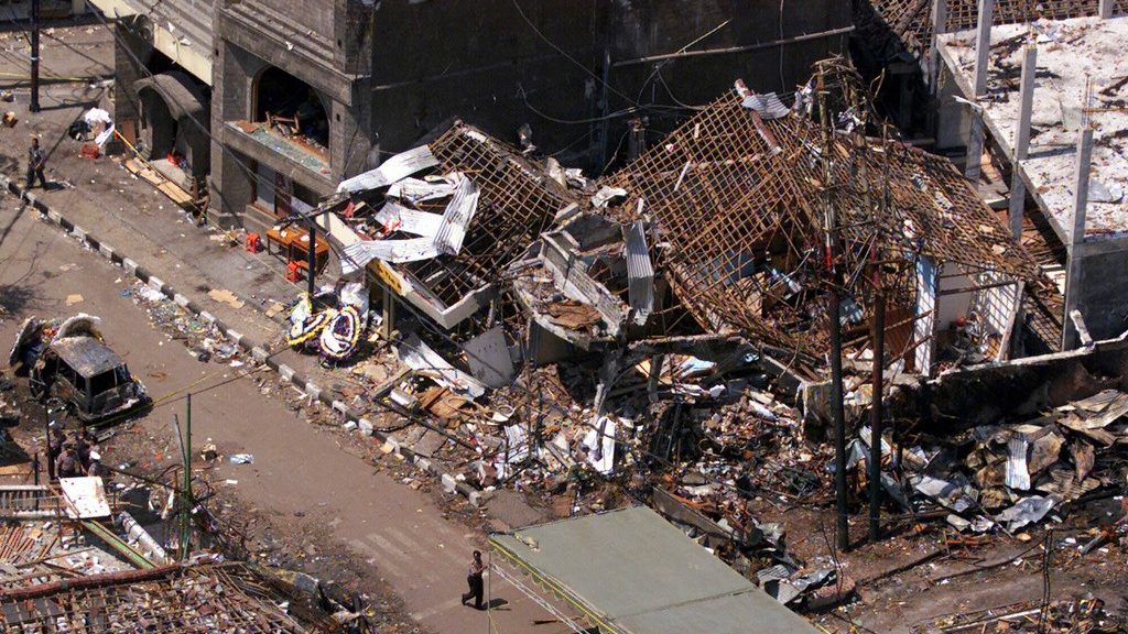 The wreckage of the Sari night club and surrounding buildings are seen in this aerial view Oct. 15, 2002 in Kuta, Bali. Two Malaysian men, both longtime detainees at Guantanamo, have pleaded guilty in connection with the bombing. (AP Photo/Achmad Ibrahim, File)