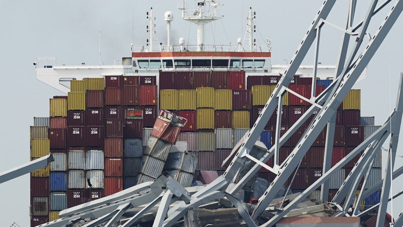 The container ship Dali is stuck under part of the Francis Scott Key Bridge after the ship hit the bridge, March 26, 2024, in Baltimore, Md. (AP Photo/Steve Helber, File)