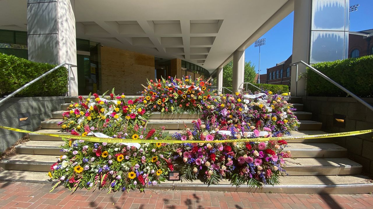 floral arrangements placed at the steps of Old National Bank in downtown Louisville
