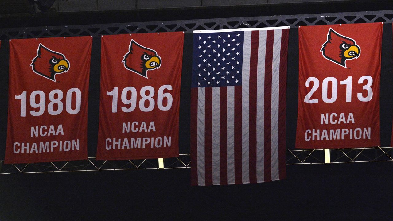 Three National Championship banners hang from the rafters at the KFC Yum! Center, the home of the University of Louisville men's basketball team, Saturday, Feb. 3, 2018, in Louisville, Ky. (AP Photo/Timothy D. Easley)