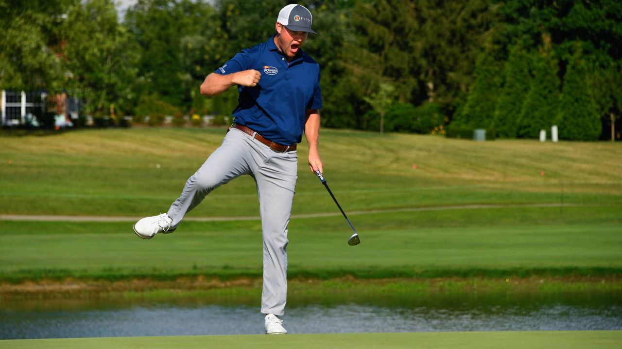 Trey Mullinax reacts after sinking a winning birdie putt on the 18th hole during the final round of the Barbasol Championship golf tournament, Sunday, July 10, 2022, in Nicholasville, Ky. (AP Photo/John Amis)