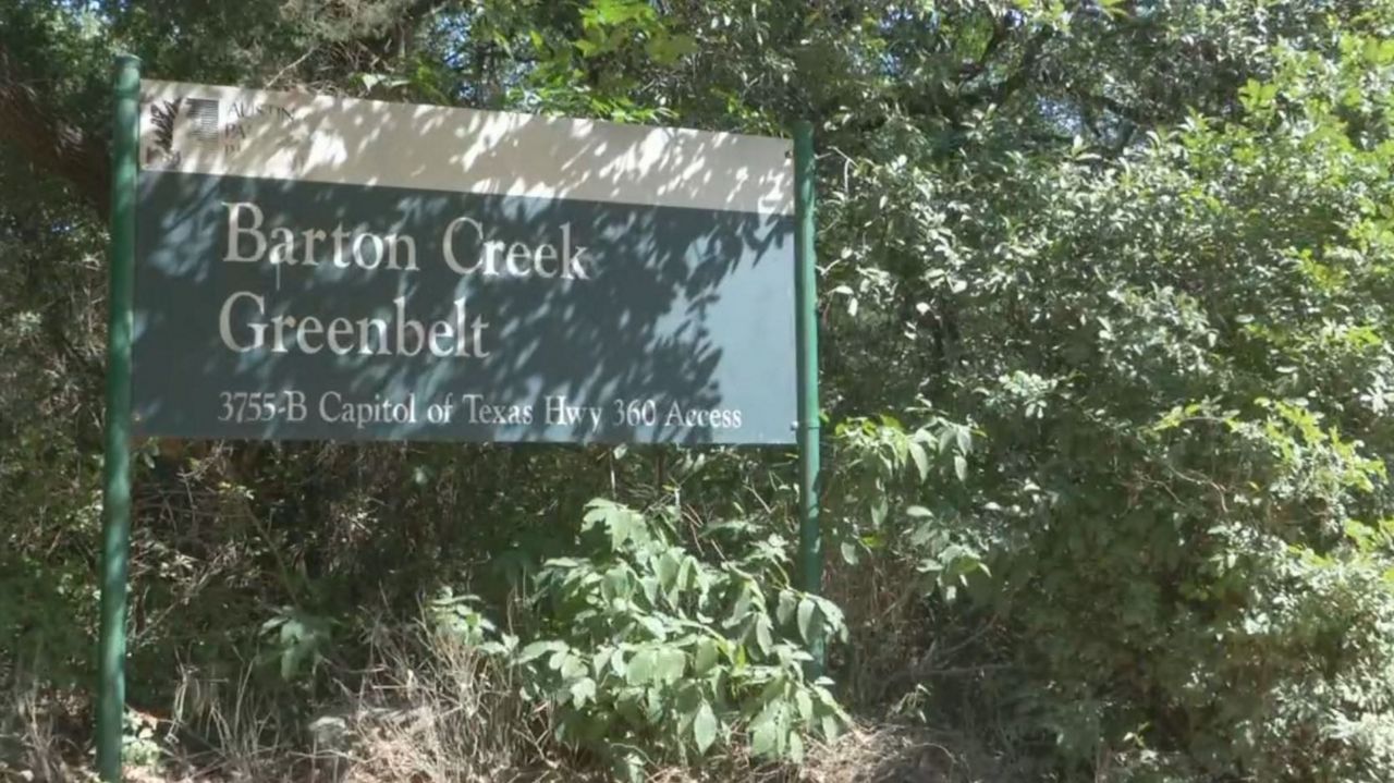 The Barton Creek Greenbelt sign surrounded by trees. (Spectrum News file footage)