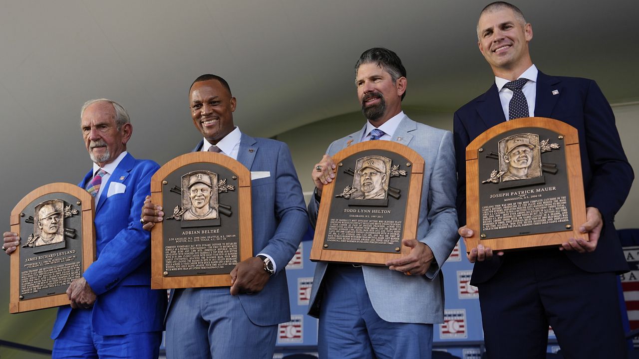 Baseball Hall of Fame inductees, from left, Jim Leyland, Adrián Beltré, Todd Helton and Joe Mauer hold their plaques at the National Baseball Hall of Fame induction ceremony, Sunday, July 21, 2024, in Cooperstown, N.Y. (AP Photo/Julia Nikhinson)