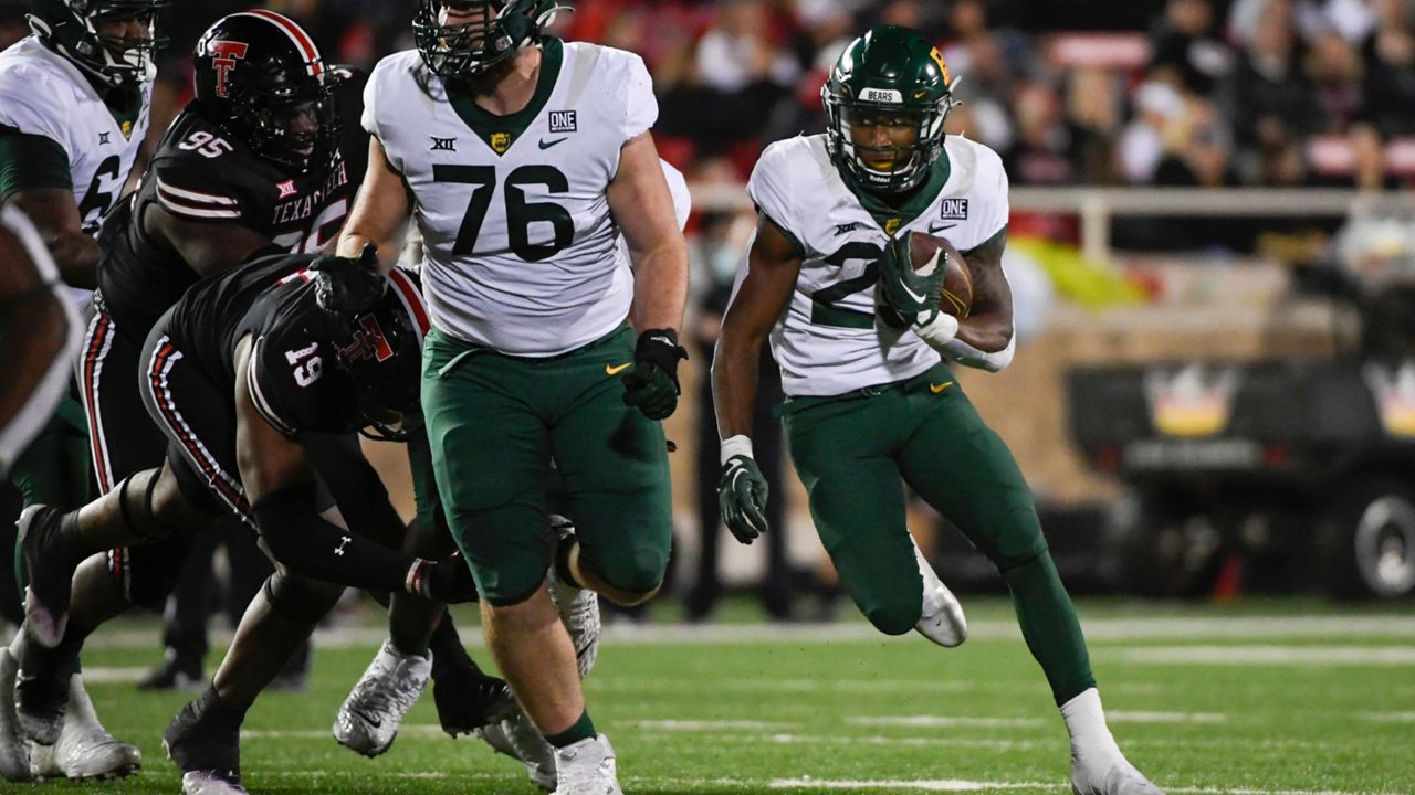 Baylor running back Richard Reese, right, runs the ball against Texas Tech during the second half of an NCAA college football game Saturday, Oct. 29, 2022, in Lubbock, Texas. (AP Photo/Justin Rex)