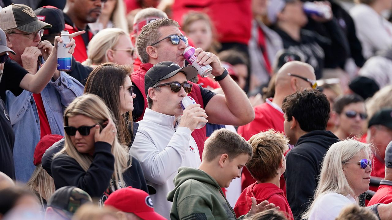 Fans drink alcoholic beverages during an NCAA college football game between Georgia and Vanderbilt, Saturday, Oct. 14, 2023, in Nashville, Tenn.