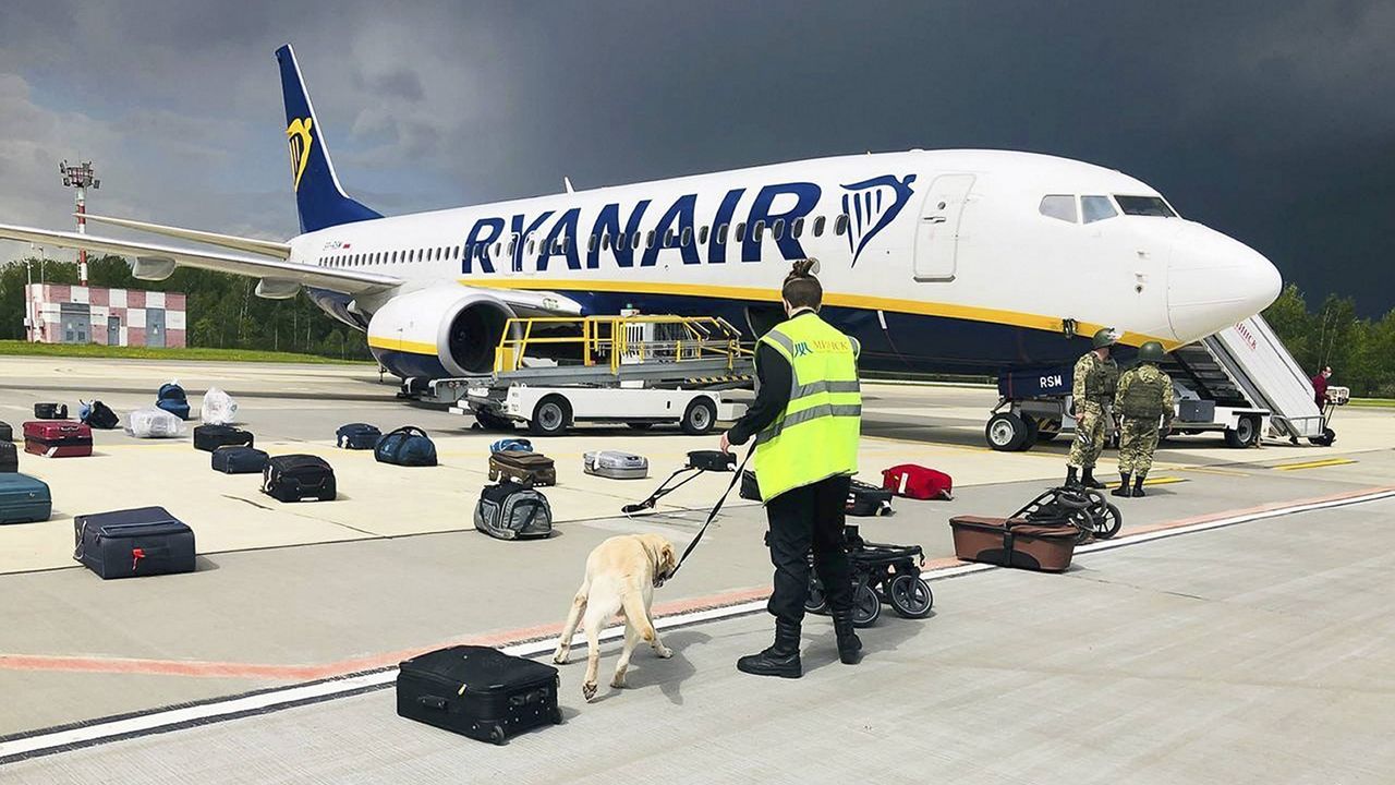 In this photo provided by ONLINER.BY, security uses a sniffer dog to check the luggage of passengers on the Ryanair plane that was carrying Belarusian opposition figure Raman Pratasevich. (ONLINER.BY via AP)