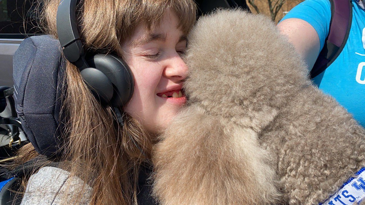 Bella Menard and her service dog Zodiac. (Spectrum News 1/Diamond Palmer)