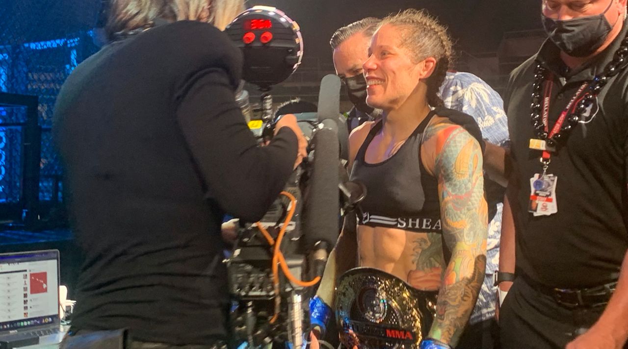 MMA veteran Liz Carmouche earned a long-awaited championship belt Friday night by defeating Bellator flyweight champion Juliana Velasquez by TKO in the fourth round.