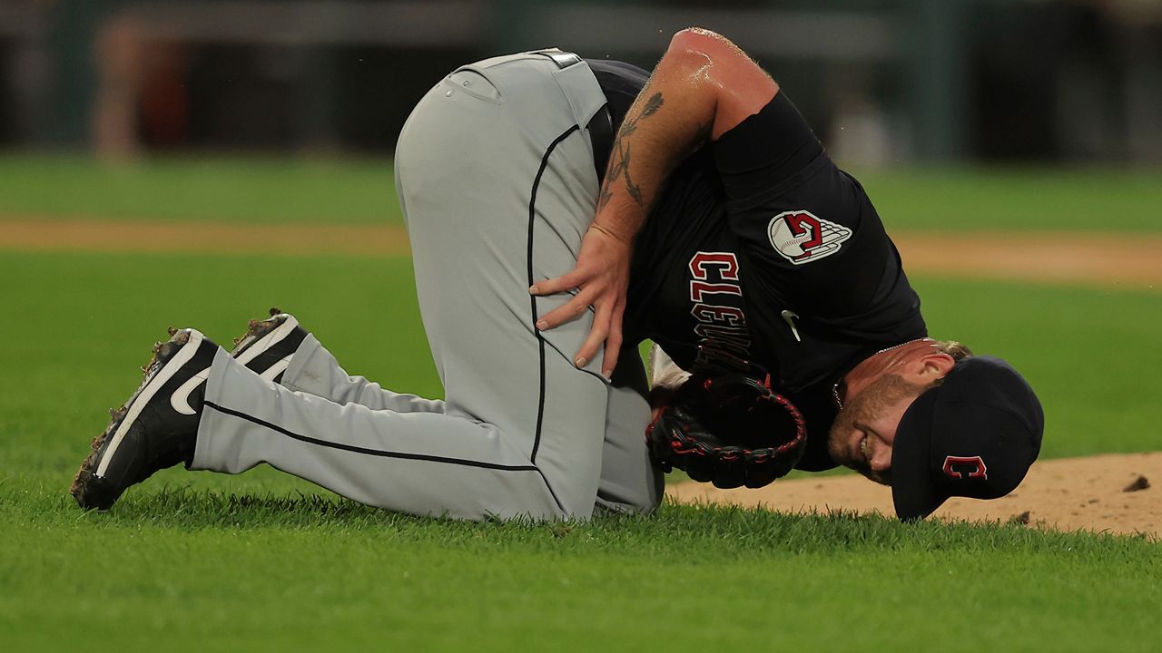 Cleveland Guardians' pitcher Ben Lively lays on the field after being hit by a ball during the second inning of a baseball game against the Chicago White Sox, Tuesday, Sept. 10, 2024, in Chicago. (AP Photo/Melissa Tamez)