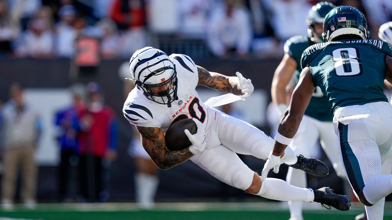 Cincinnati Bengals running back Chase Brown, left, dives in for a touchdown in front of Philadelphia Eagles safety C.J. Gardner-Johnson (8) during the second half of an NFL football game, Sunday, Oct. 27, 2024 in Cincinnati. (AP Photo/Carolyn Kaster)