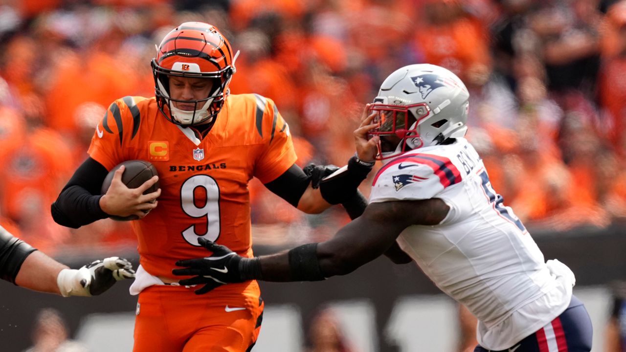 Cincinnati Bengals quarterback Joe Burrow (9) runs from New England Patriots linebacker Ja'Whaun Bentley (8) during the second half of an NFL football game, Sunday, Sept. 8, 2024, in Cincinnati.