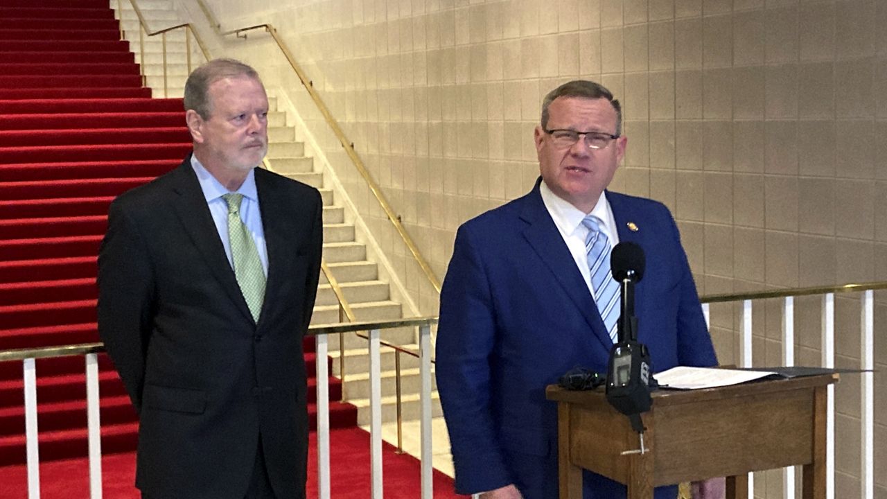 North Carolina House Speaker Tim Moore, R-Cleveland, speaks to reporters while Senate leader Phil Berger, R-Rockingham, listens at the Legislative Building in Raleigh, N.C., on Tuesday, Sept. 19, 2023. Moore and Berger announced that Republican legislative leaders were ditching efforts this year to dramatically multiply legal gambling in the state and that instead, they would pass a final budget that also will trigger Medicaid coverage to begin for hundreds of thousands of adults. (AP Photo/Gary D. Robertson)