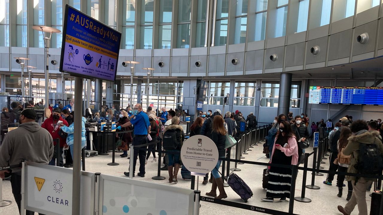 Travelers stand in line at a TSA security checkpoint at Austin-Bergstrom International Airport. (AP Photo/Ashley Landis)