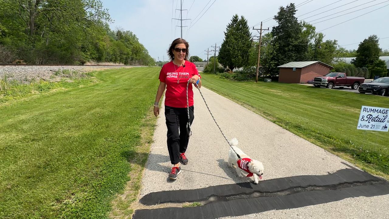 Heather Berken walks with her dog, Troubles ahead of this weekend's march.