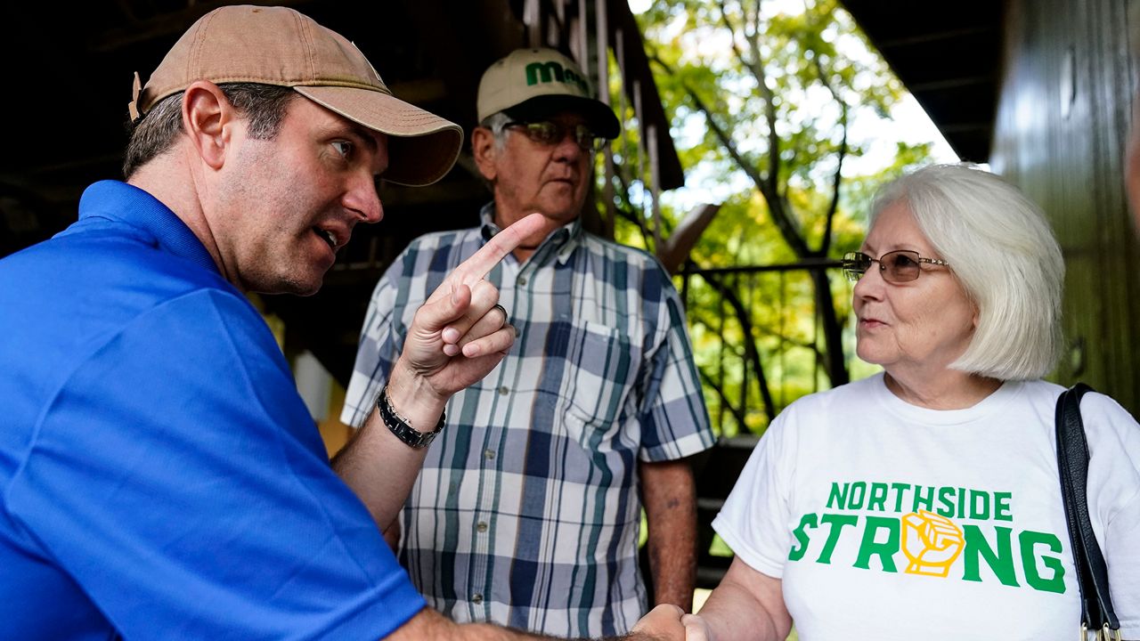 Kentucky Governor Andy Beshear, center, talks with residents that have been displaced by floodwaters at Jenny Wiley State Resort Park Saturday, Aug. 6, 2022, in Prestonsburg, Ky. (AP Photo/Brynn Anderson)