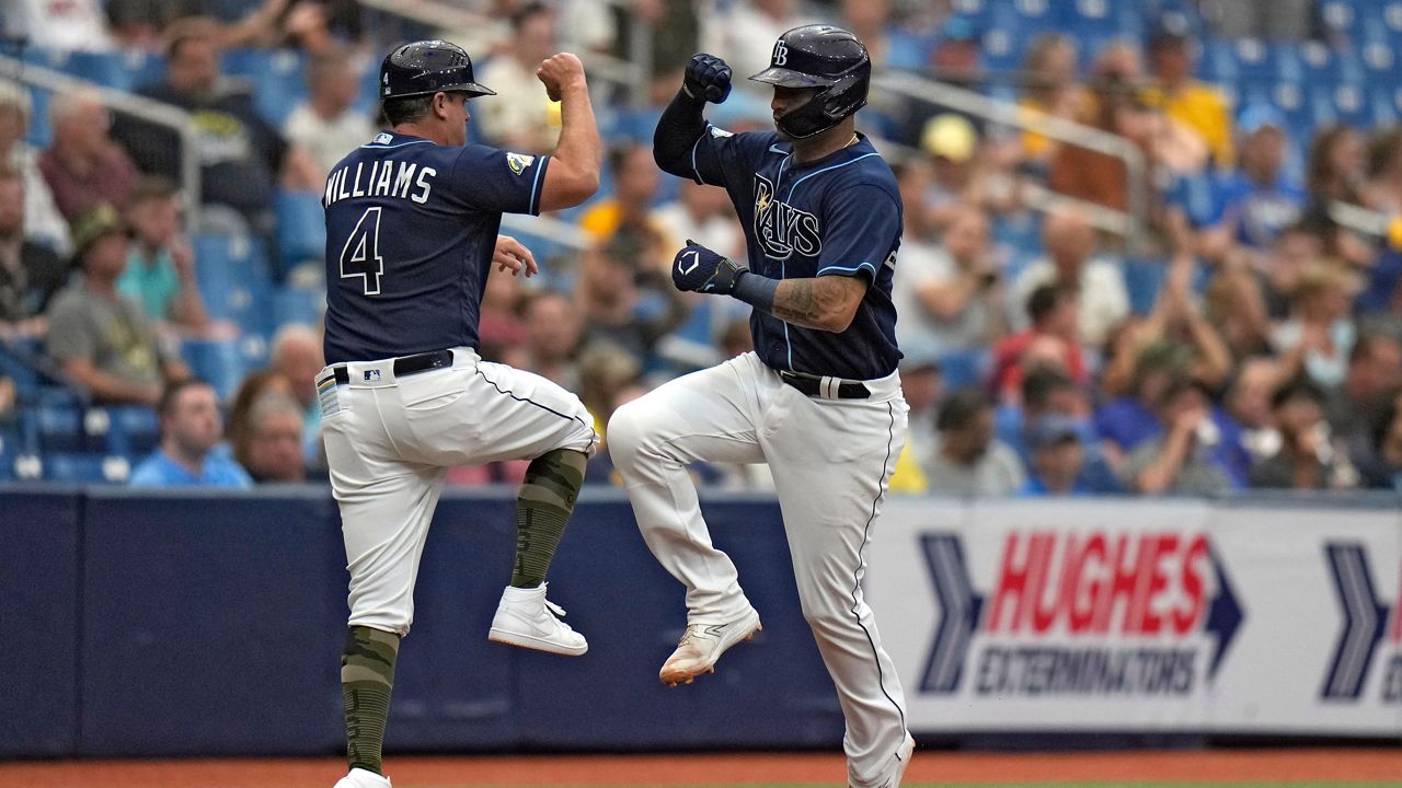 Tampa Bay Rays' Christian Bethancourt celebrates his solo home run off Milwaukee Brewers starting pitcher Eric Lauer with third base coach Brady Williams (4) during the fourth inning of a baseball game Saturday, May 20, 2023, in St. Petersburg, Fla. (AP Photo/Chris O'Meara)