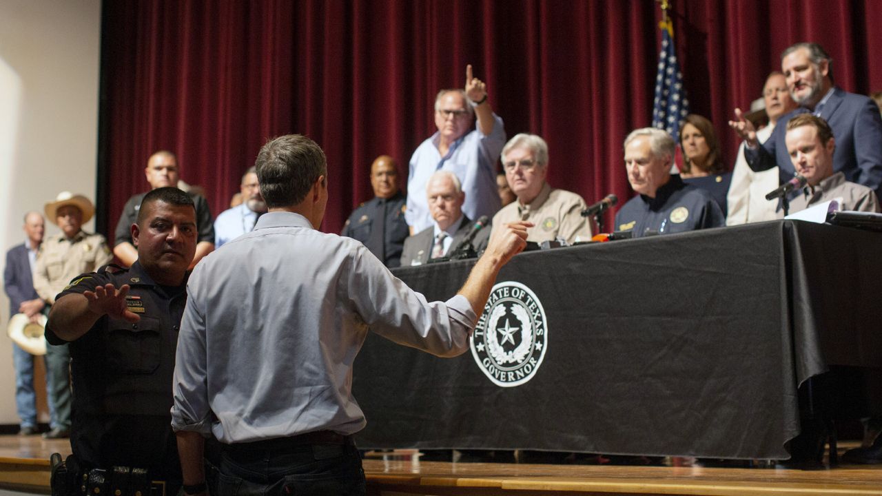 Democrat Beto O'Rourke, who is running against Greg Abbott for governor in 2022, interrupts a news conference headed by Texas Gov. Greg Abbott in Uvalde, Texas Wednesday, May 25, 2022. (AP Photo/Dario Lopez-Mills)