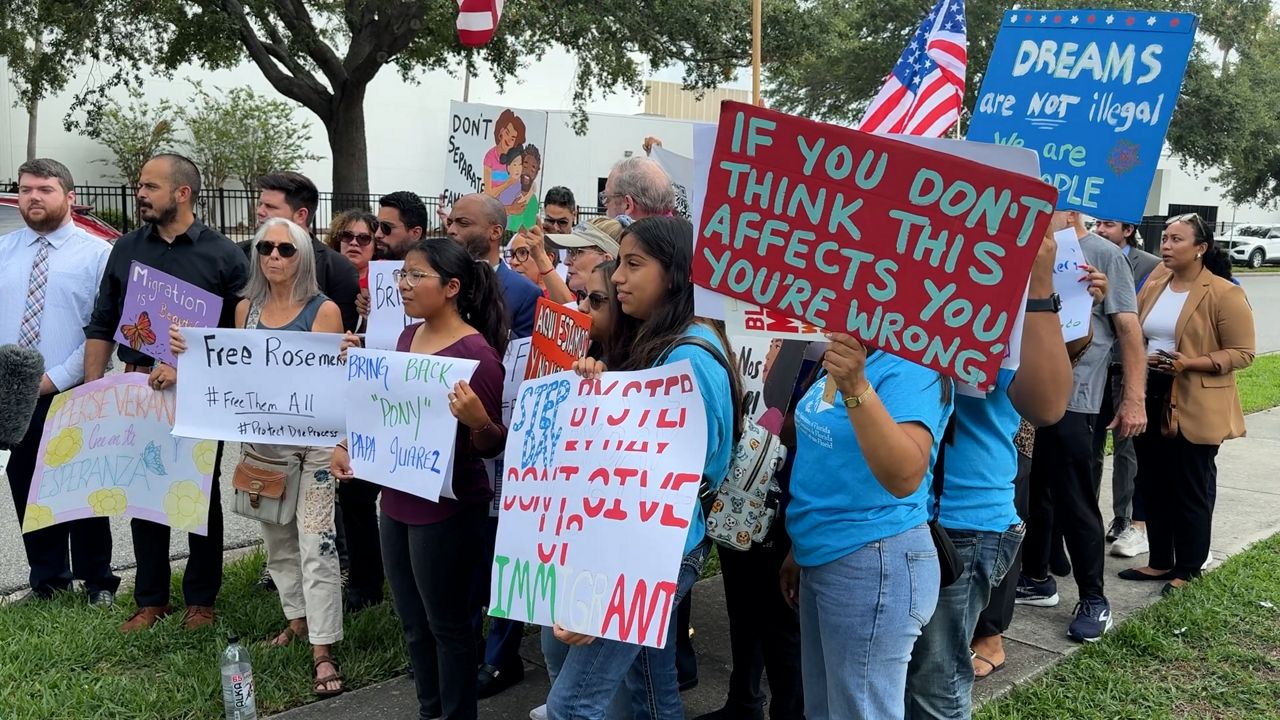 Beverly Juarez, 21, holds a sign that reads 