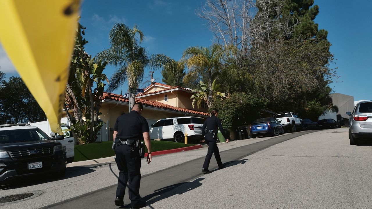 Police block the street to a house where three people were killed and four others wounded in a shooing at a short-term rental home in an upscale Los Angeles neighborhood on Saturday Jan. 28, 2023. The shooting occurred about 2:30 a.m. in the Beverly Crest neighborhood. (AP Photo/Richard Vogel)