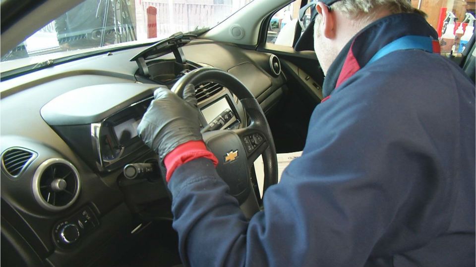 image of man working on car