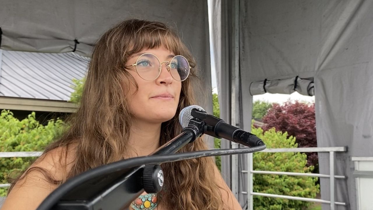 Female musician at a microphone.