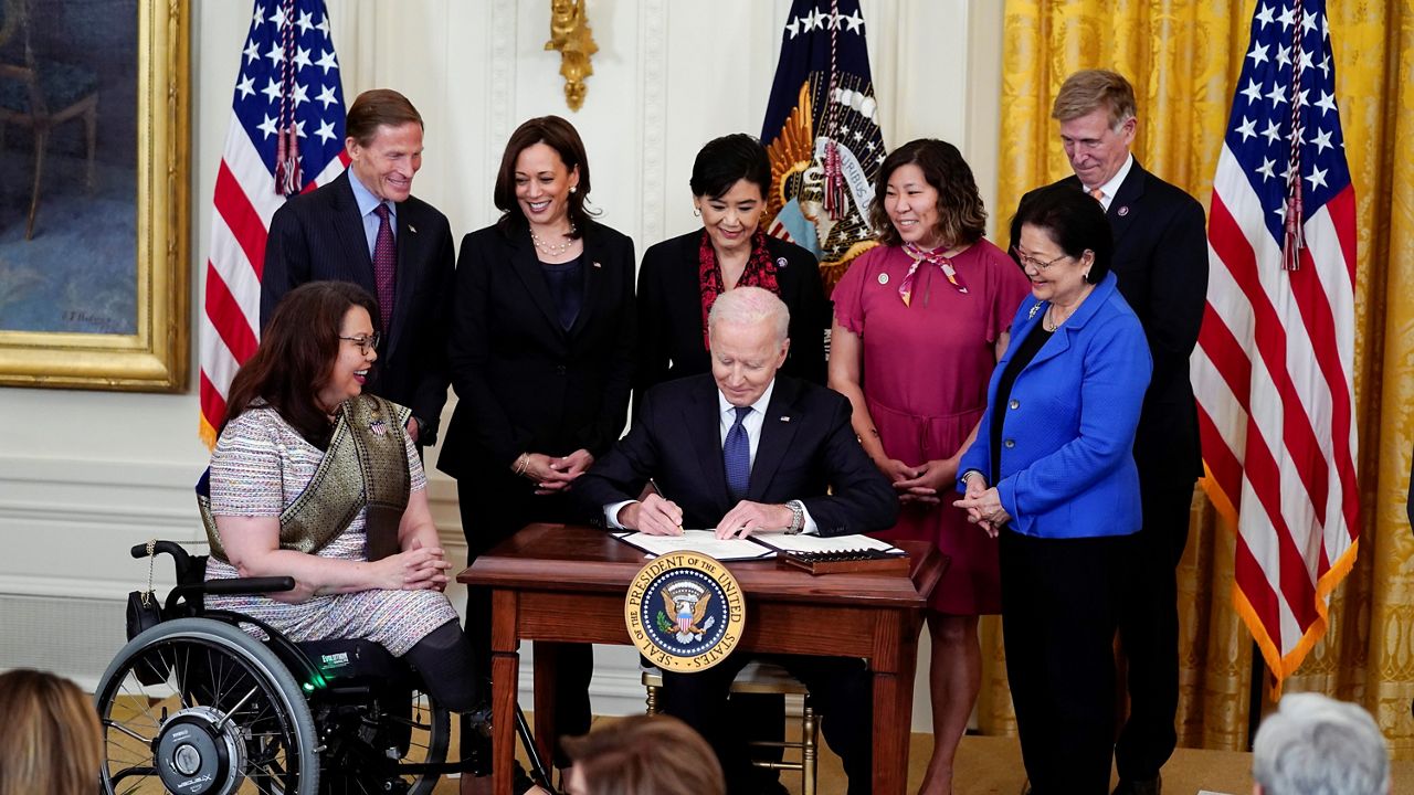 President Biden signs the COVID-19 Hate Crimes Act on May 20, 2021. (AP/Evan Vucci)