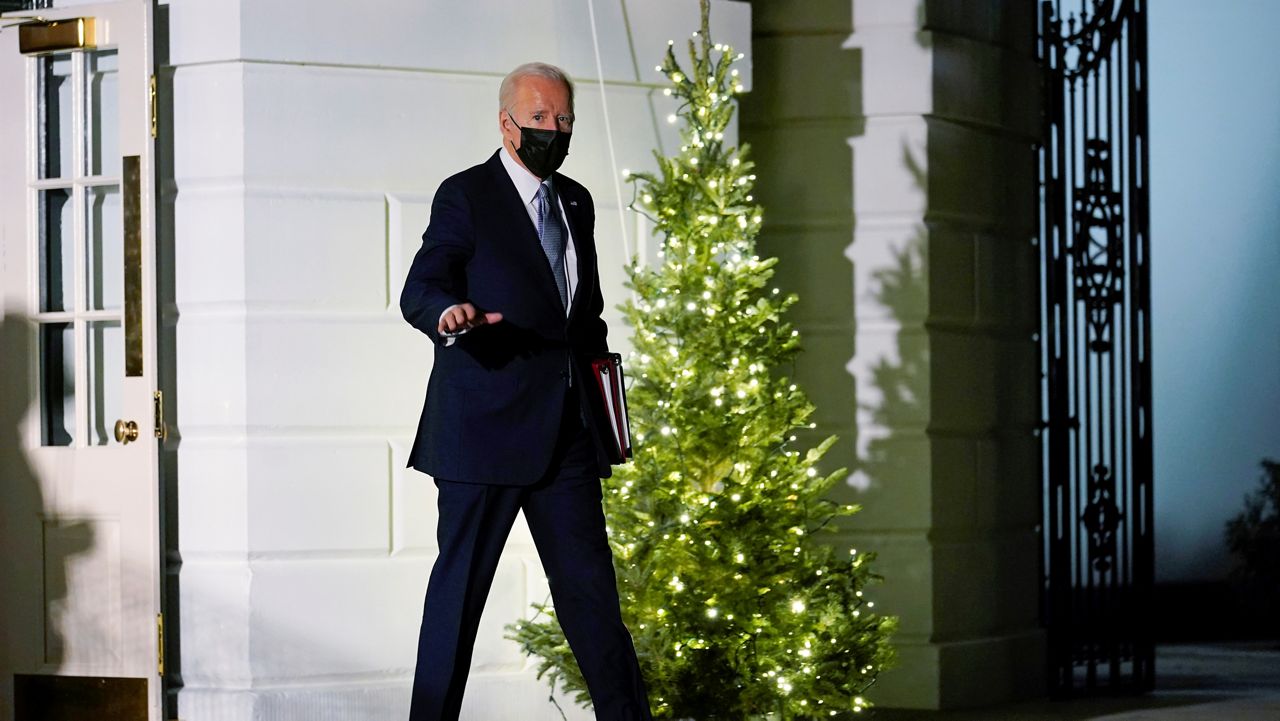 President Joe Biden waves as he walks to Marine One on the South Lawn of the White House in Washington, Friday, Dec. 3, 2021, as he prepares to leave for Camp David. (AP Photo/Susan Walsh)