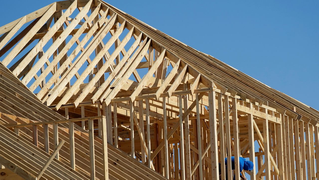 Construction workers erect the frames of a home in a new subdivision in Allen, Texas. (AP/Tony Gutierrez)