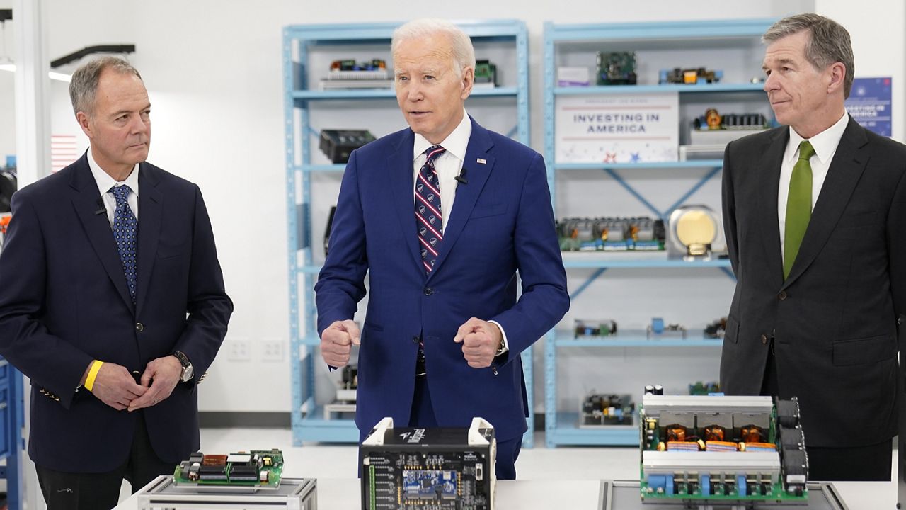 President Joe Biden tours semiconductor manufacturer Wolfspeed Inc., in Durham, N.C., Tuesday, March 28, 2023, with CEO Gregg Lowe and North Carolina Gov. Roy Cooper, right.