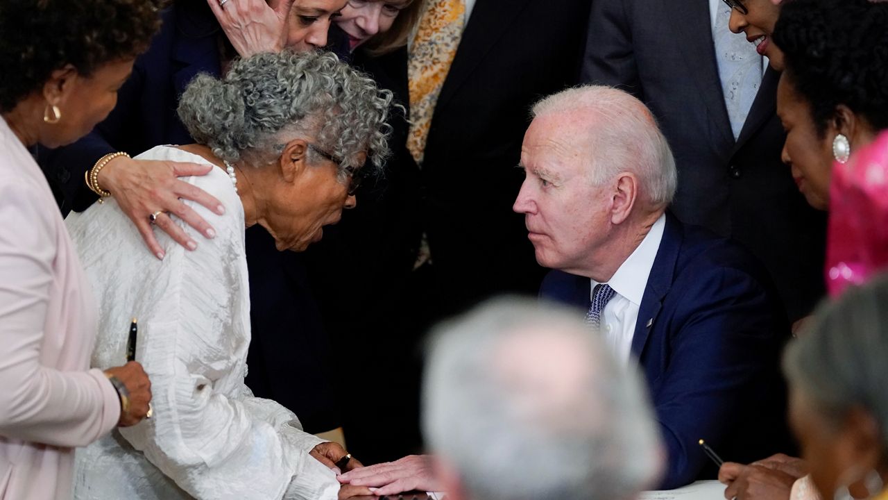 After signing the Juneteenth National Independence Day Act, President Joe Biden speaks with Opal Lee. She's known as the "Grandmother of Juneenth" for her years advocating for Juneteenth to be declared a federal holiday. (Evan Vucci/AP)