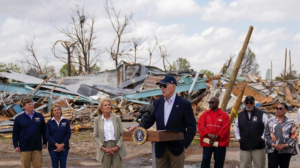 President Joe Biden speaks after surveying the damage in Rolling Fork, Miss., Friday, March 31, 2023, after a deadly tornado and severe storm moved through the area. From left, Mississippi Gov. Tate Reeves and his wife Elee Reeves, first lady Jill Biden, Biden, Rolling Fork Mayor Eldridge Walker, Rep. Bennie Thompson, D-Miss., and Housing and Urban Development Secretary Marcia Fudge. (AP Photo/Carolyn Kaster)