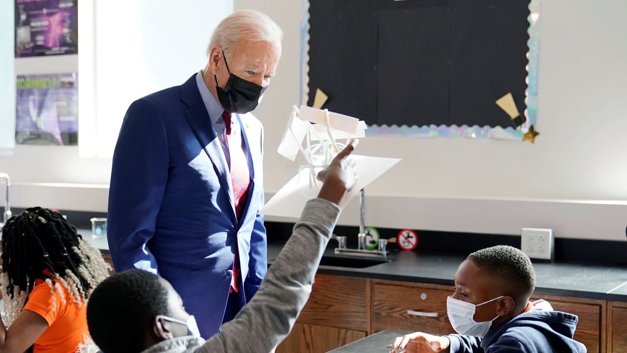 President Joe Biden stops to look at a student's project as he tours Brookland Middle School, Friday, Sept. 10, 2021 in Washington. (AP/Manuel Balce Ceneta)