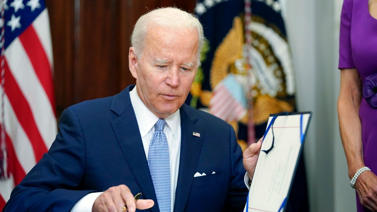 President Joe Biden signs into law the Bipartisan Safer Communities Act gun safety bill on June 25 in the Roosevelt Room of the White House. (AP Photo/Pablo Martinez Monsivais, File)