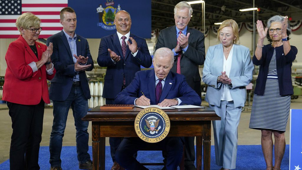President Joe Biden signs an executive order to encourage companies to manufacture new inventions in the United States at Auburn Manufacturing Inc., in Auburn, Maine, Friday, July 28, 2023. From left, Rep. Chellie Pingree, D-Maine, Rep. Jared Golden, D-Maine, Auburn, Maine Mayor Jason Levesque, Sen. Angus King, I-Maine, Maine Gov. Janet Mills, and Kathie Leonard, CEO of Auburn Manufacturing. (AP Photo/Susan Walsh)