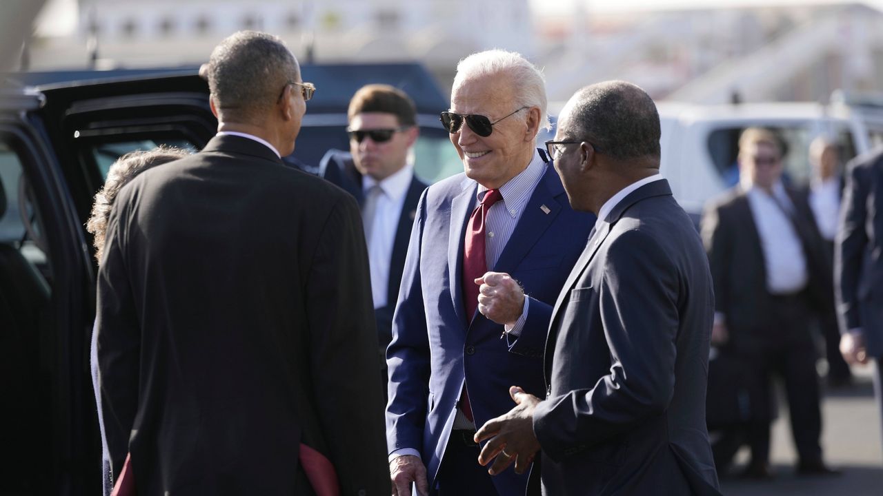 President Joe Biden speaks with Cape Verde's Prime Minister Ulisses Correia e Silva, right, and Jose Luis Livramento, Cabo Verde Ambassador to the U.S at Amilcar Cabral international airport on Sal island, Cape Verde, on Monday, Dec. 2, 2024, en route to Angola as he makes his long-promised visit to Africa. (AP Photo/Ben Curtis)