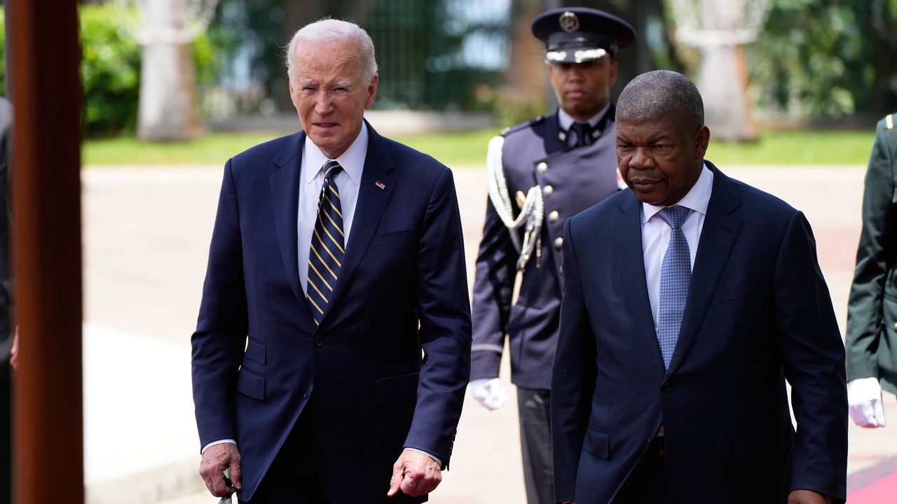 President Joe Biden inspects the honor guard with Angola's President Joao Lourenco at the presidential palace in Luanda, Angola, on Tuesday, Dec. 3, 2024. (AP Photo/Ben Curtis)