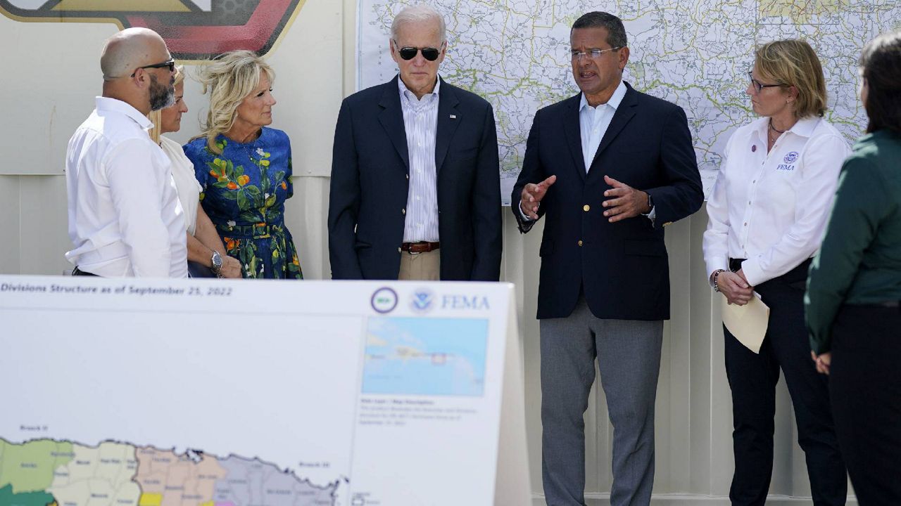 President Joe Biden and first lady Jill Biden, receive a briefing from Puerto Rico Gov. Pedro Pierluisi on Hurricane Fiona, Monday, Oct. 3, 2022, in Ponce, Puerto Rico. (AP Photo/Evan Vucci)