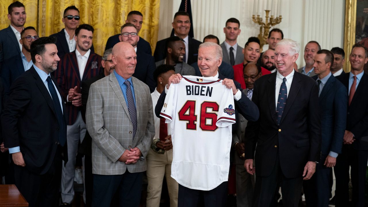 President Joe Biden holds up a jersey Monday during an event celebrating the 2021 World Series champion Atlanta Braves in the East Room of the White House. (AP Photo/Evan Vucci)