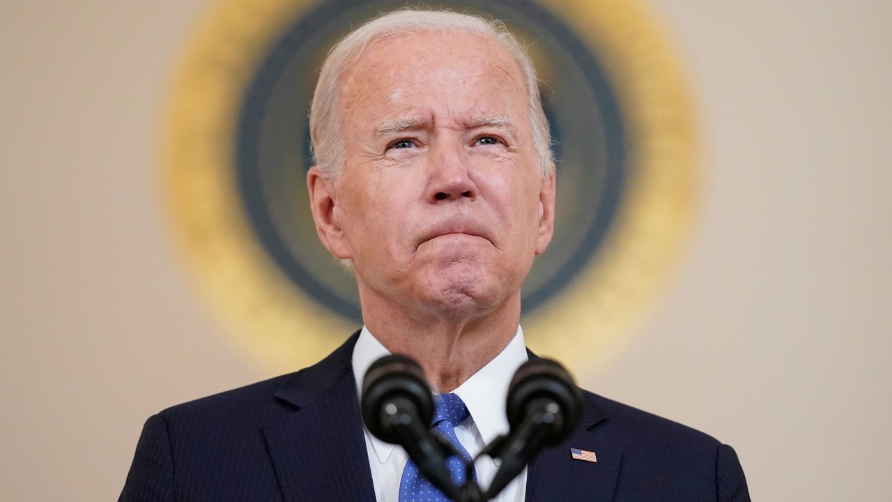 Joe Biden stands and speaks.