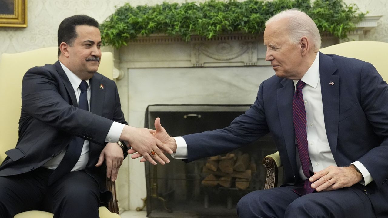 President Joe Biden, right, and Iraqi Prime Minister Shia al-Sudani shake hands during a meeting in the Oval Office of the White House, Monday, April 15, 2024, in Washington. (AP Photo/Alex Brandon)