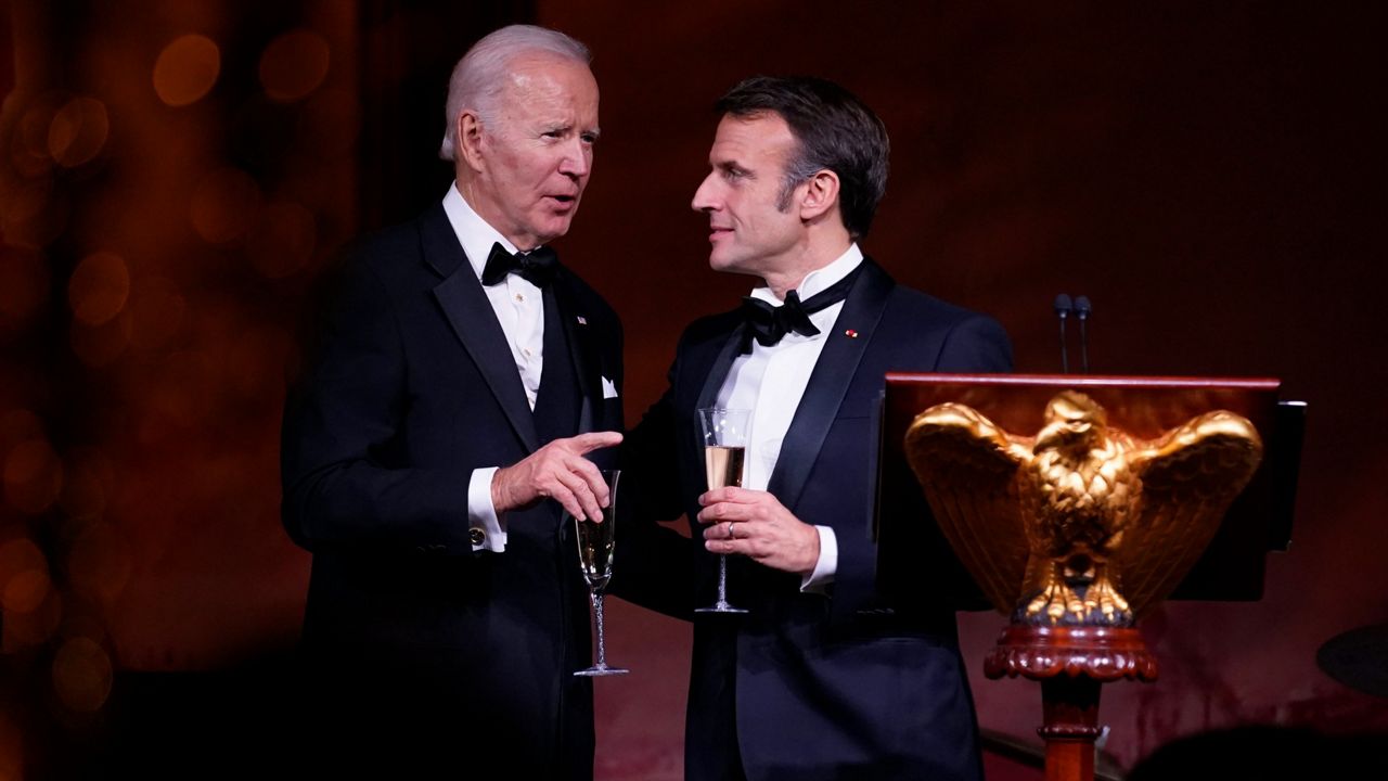President Joe Biden and French President Emmanuel Macron talk Thursday after a toast during a state dinner on the South Lawn of the White House. (AP Photo/Andrew Harnik)