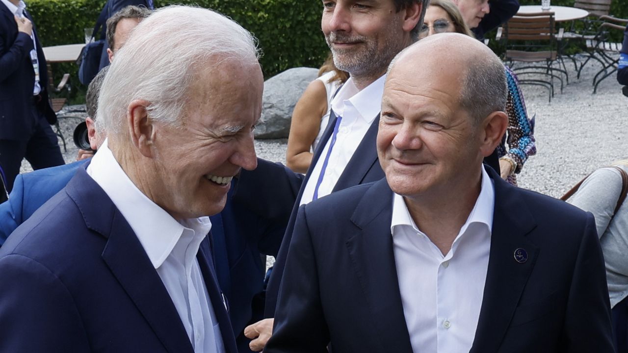 German Chancellor Olaf Scholz, front right, and U.S. President Joe Biden, front left, speak to each other at Castle Elmau in Kruen, Germany, Sunday, June 26, 2022. (Jonathan Ernst/Pool Photo via AP, File)