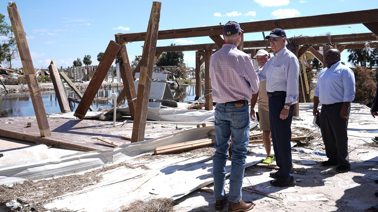 President Joe Biden speaks with Sen. Rick Scott, R-Fla., in Keaton Beach, Fla., Thursday, Oct. 3, 2024, during his tour of areas impacted by Hurricane Helene. (AP Photo/Susan Walsh)