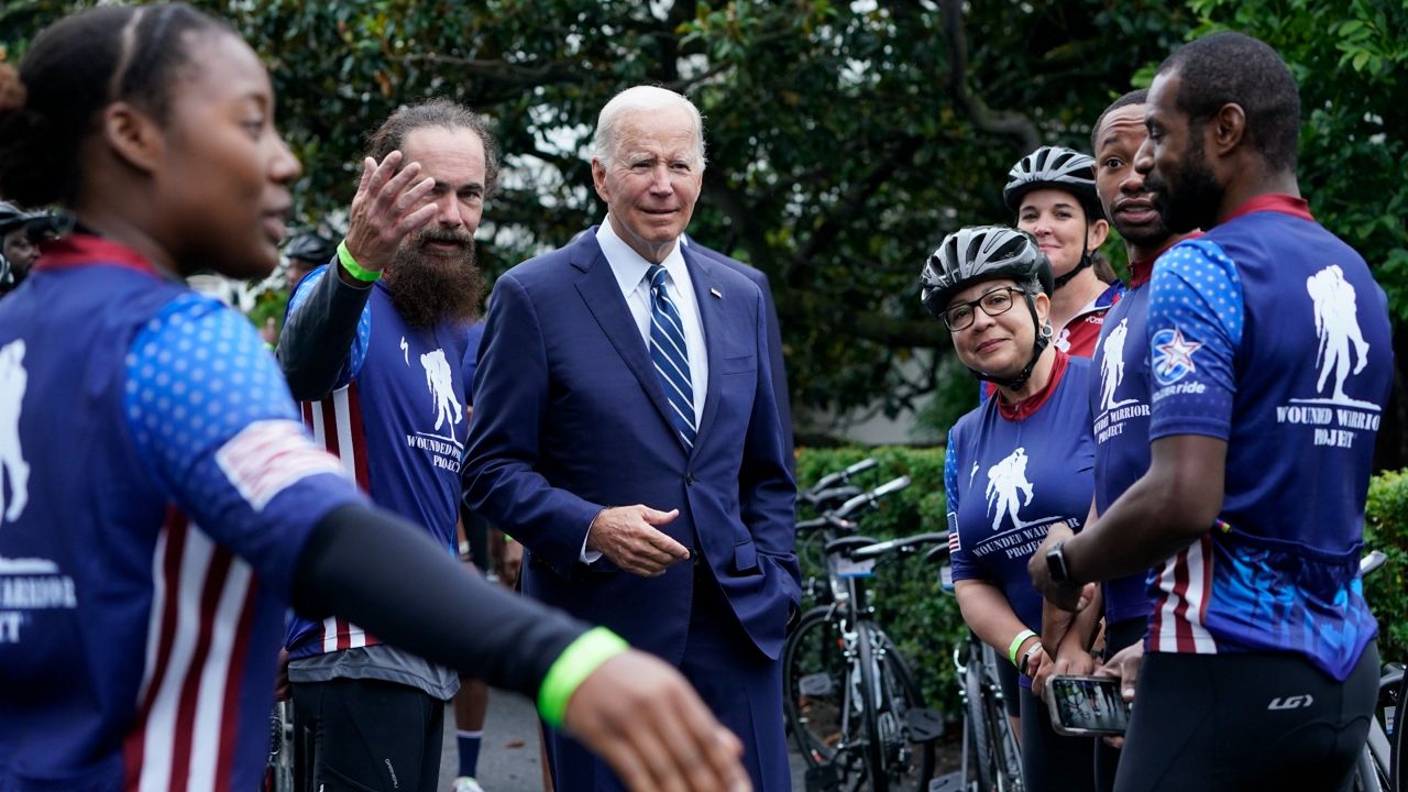 President Joe Biden talks Thursday to riders at the White House during an event to welcome wounded warriors, their caregivers and families to the White House as part of the annual Soldier Ride. (AP Photo/Susan Walsh)