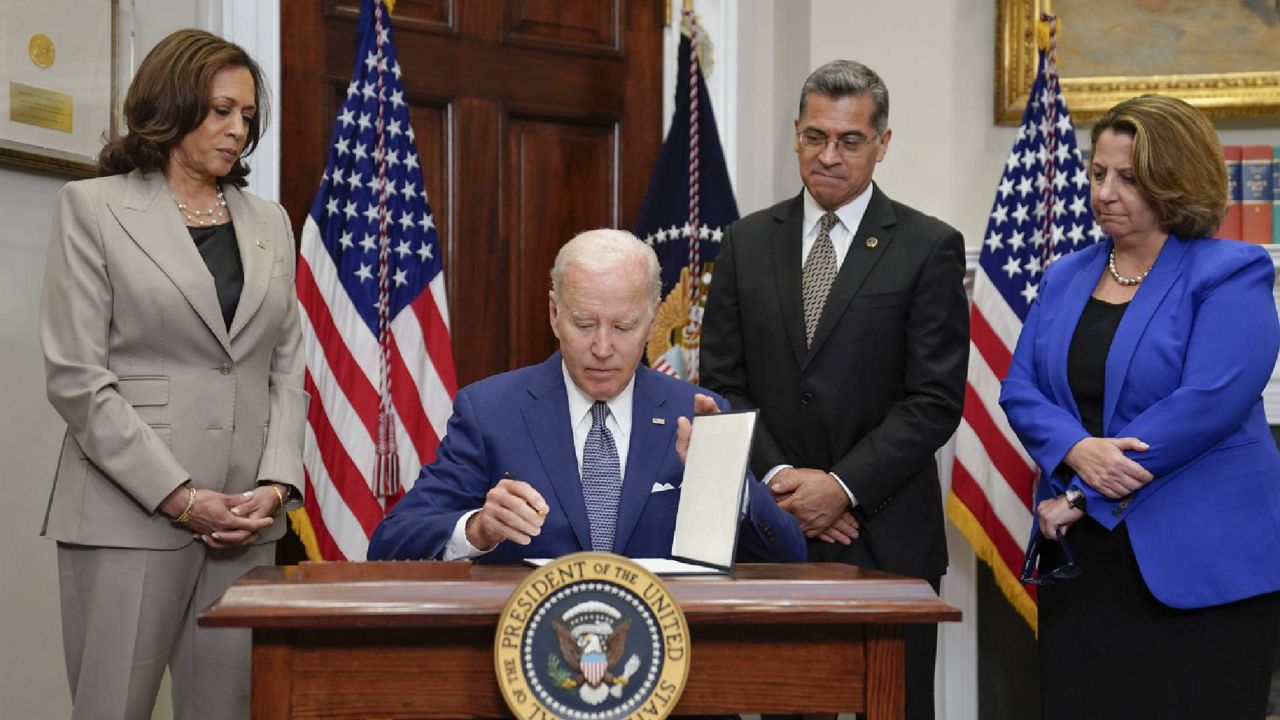 FILE - President Joe Biden signs an executive order on abortion access during an event in the Roosevelt Room of the White House, Friday, July 8, 2022, in Washington. (AP Photo/Evan Vucci)
