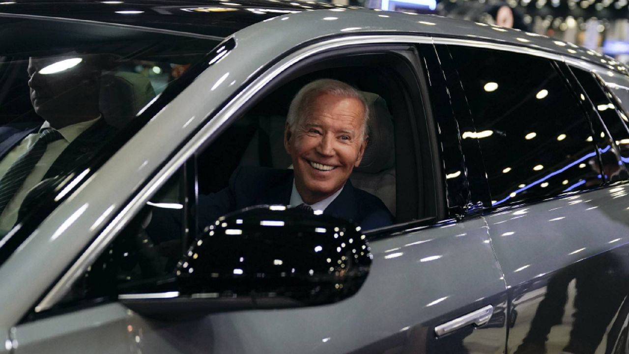 President Joe Biden drives a Cadillac Lyriq through the show room during a tour at the Detroit Auto Show, Wednesday, Sept. 14, 2022, in Detroit. (AP Photo/Evan Vucci)