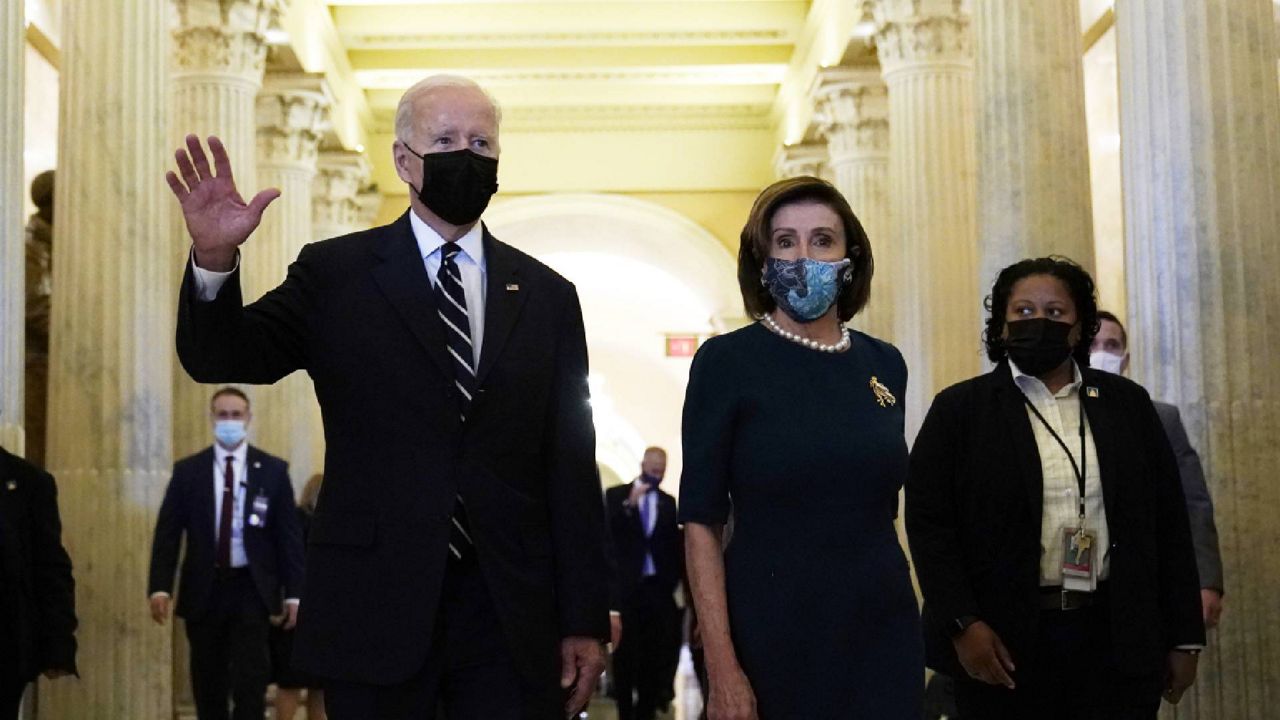 President Biden walks with House Speaker Nancy Pelosi on Capitol Hill in Washington, Thursday, Oct. 28, 2021, following a visit to meet with House Democrats. (AP Photo/Susan Walsh)