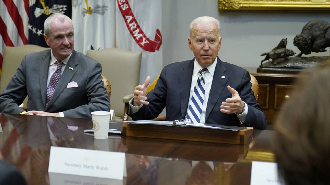President Joe Biden, right, sitting next to New Jersey Governor Phil Murphy, left, speaks during a meeting with a bipartisan group of governors and mayors in the Roosevelt room of the White House in Washington, Wednesday, July 14, 2021, to discuss the bipartisan infrastructure deal in the Senate. (AP Photo/Susan Walsh)