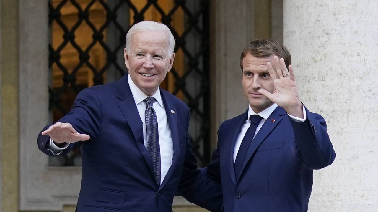 U.S. President Joe Biden, left, and French President Emmanuel Macron wave prior to a meeting at La Villa Bonaparte in Rome, Friday, Oct. 29, 2021. (AP Photo/Evan Vucci)